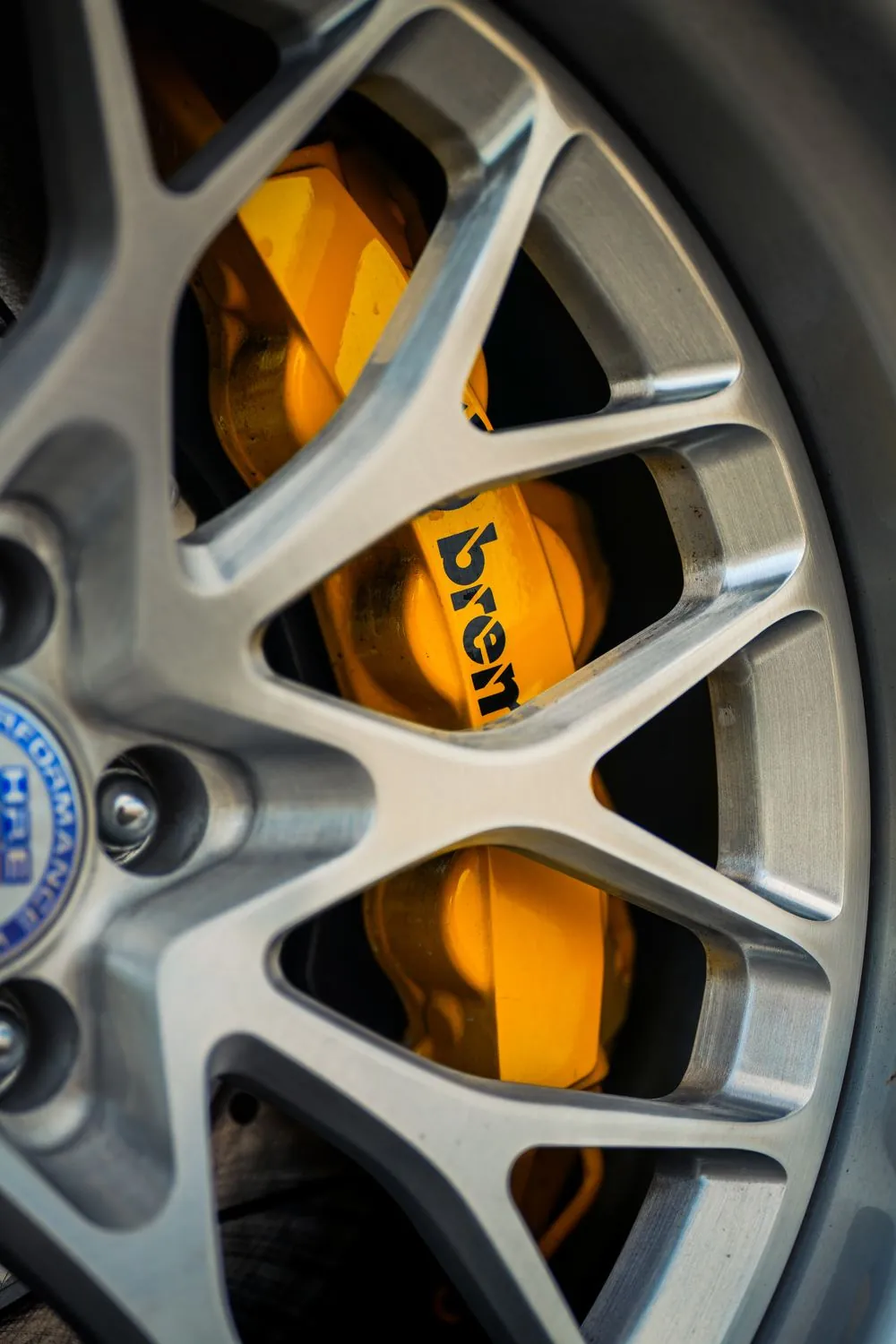 Orange brake caliper behind the wheel