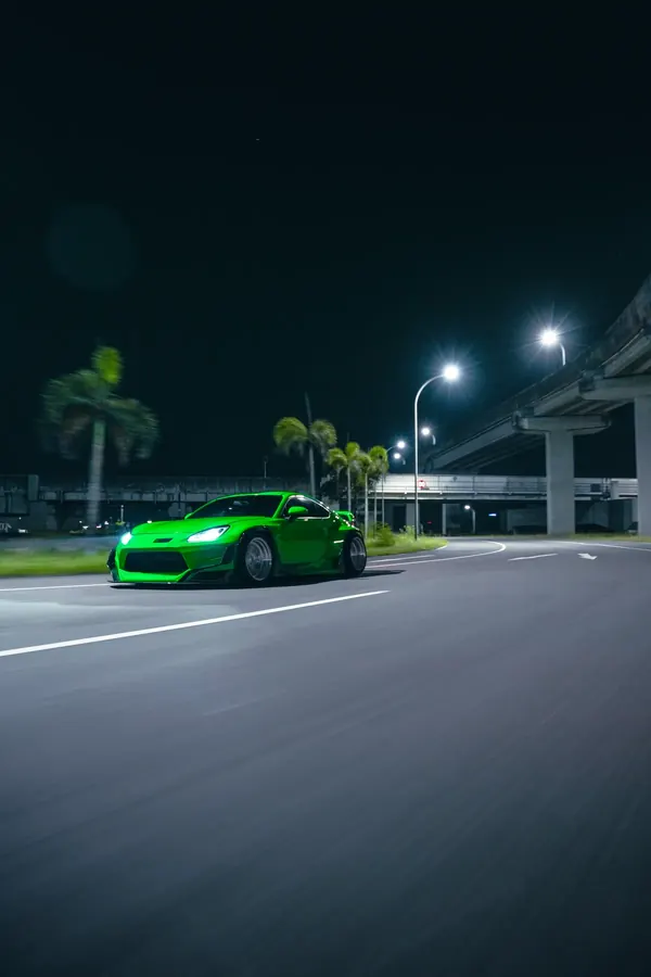 GR86 widebody on the move past palm trees at night