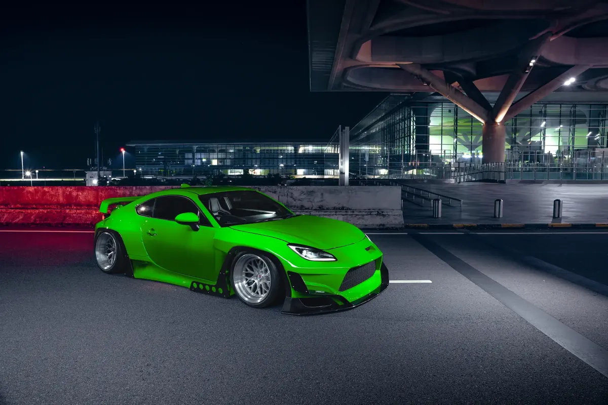 GR86 widebody at night by the airport terminal