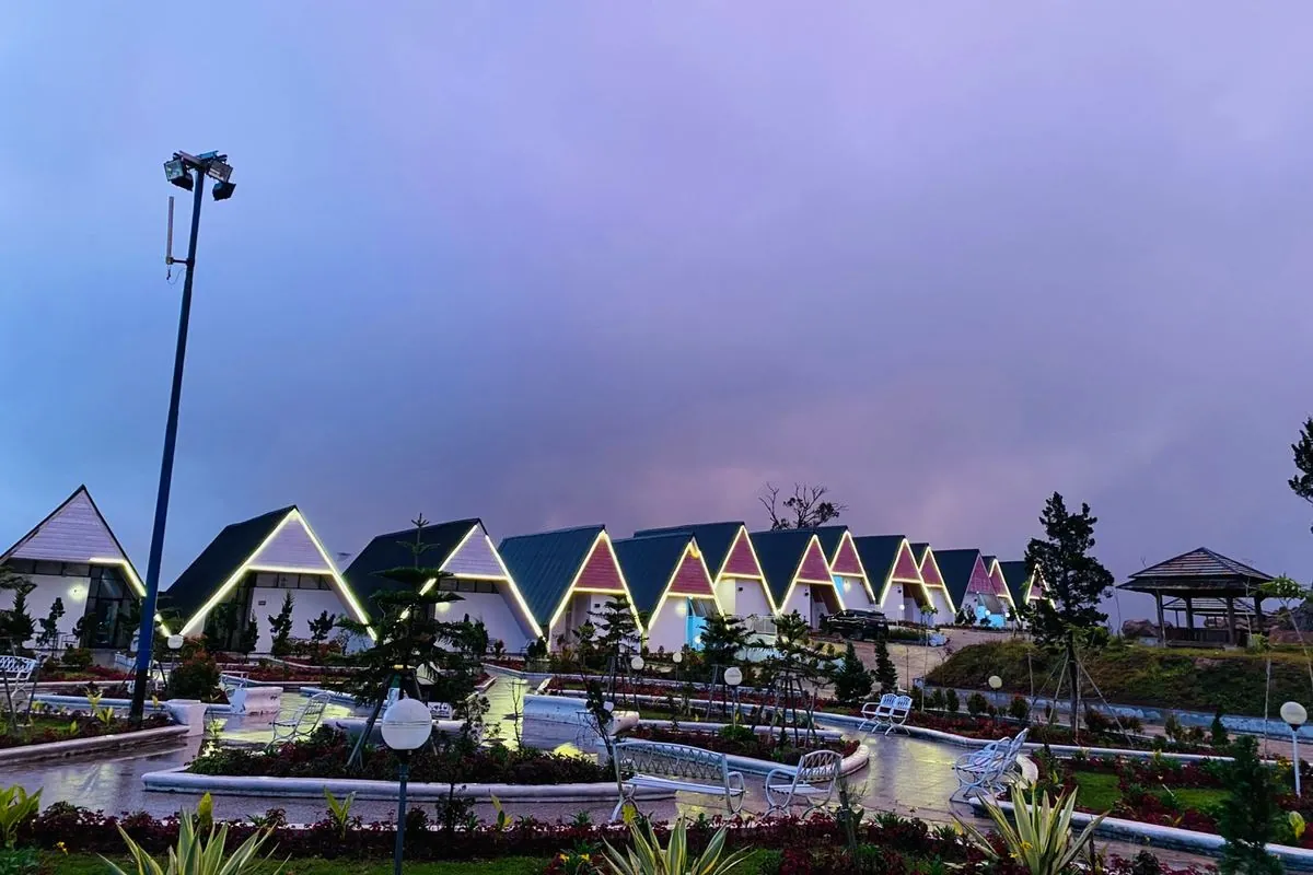 Cambai Hill A-frame cabins lit up at dusk
